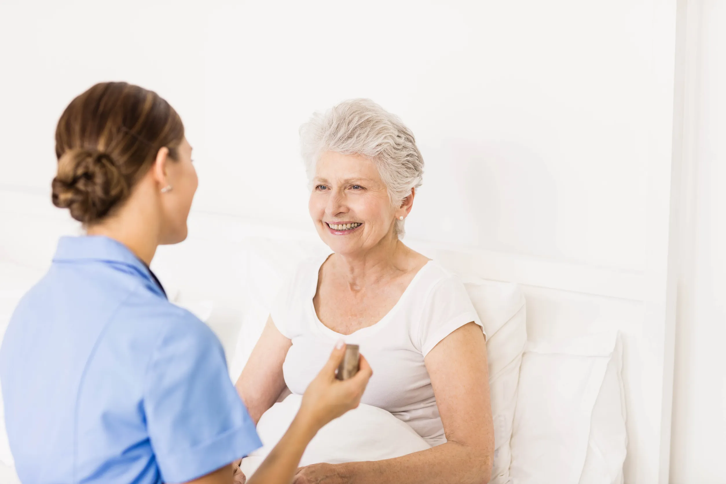 Nurse taking care of suffering senior patient at home Nurse taking care of suffering senior patient at home